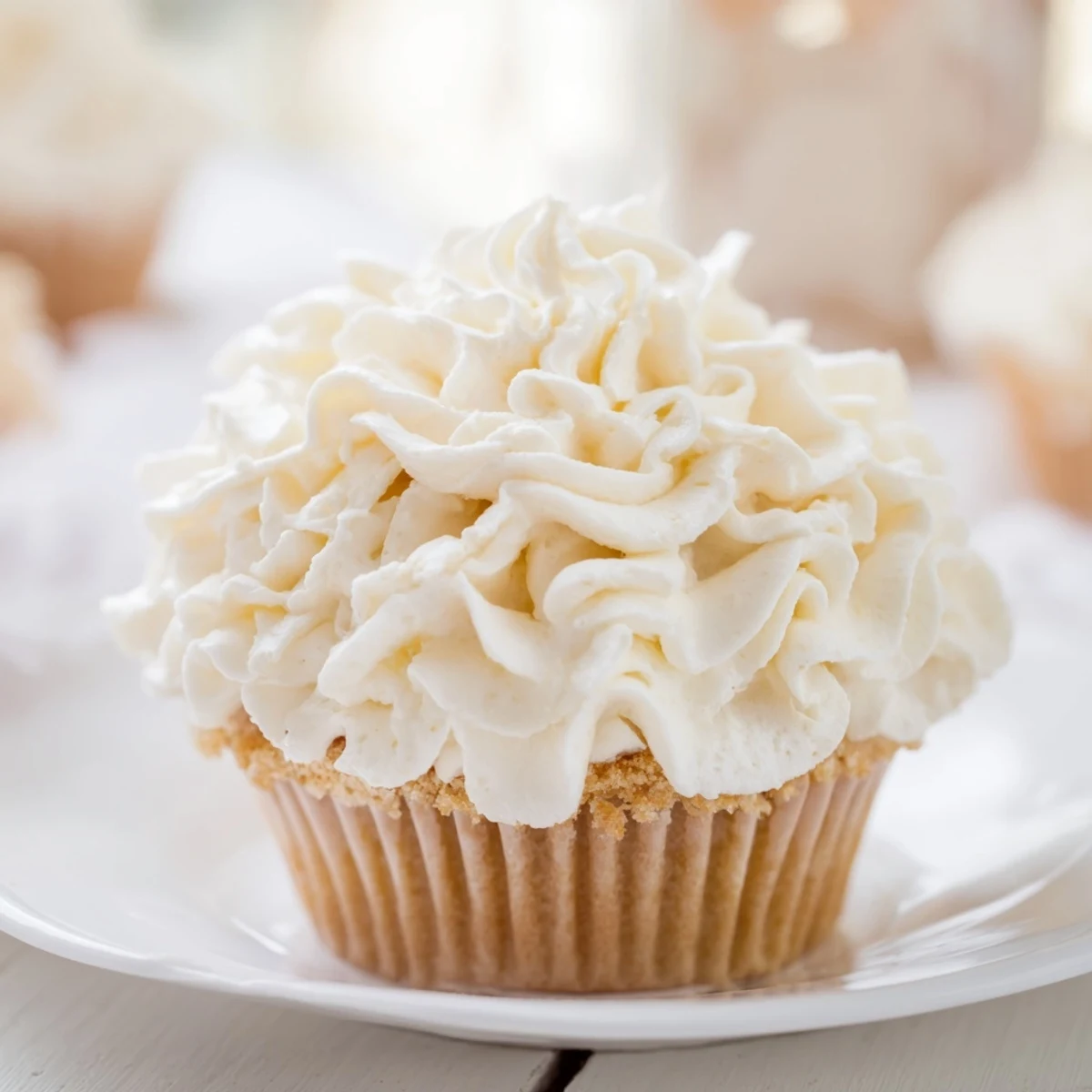 These delicious vanilla cupcakes feature a generous topping of perfectly smooth buttercream frosting, ready to eat.