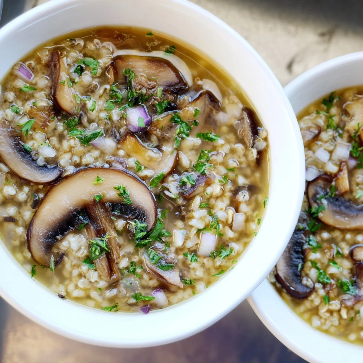 Steaming bowl of Wild Mushroom and Barley Soup, garnished with fresh parsley, ready to enjoy.