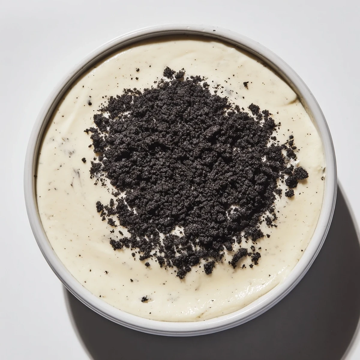 This picture shows a beautiful serving of vanilla pudding with crushed Oreos, ready to enjoy.