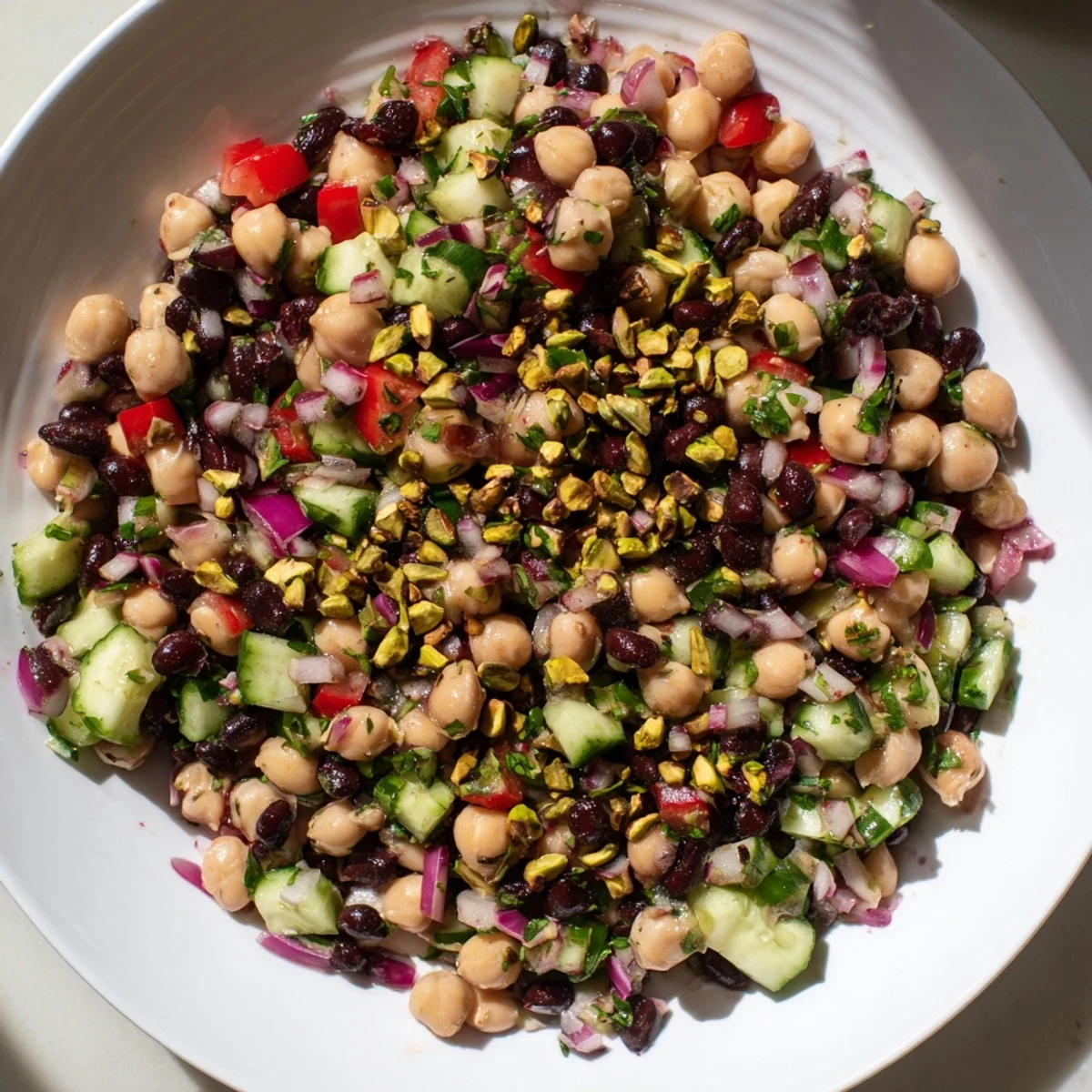 Vibrant Dense Bean Salad, studded with red bell peppers and rich cacao nibs, ready to serve.