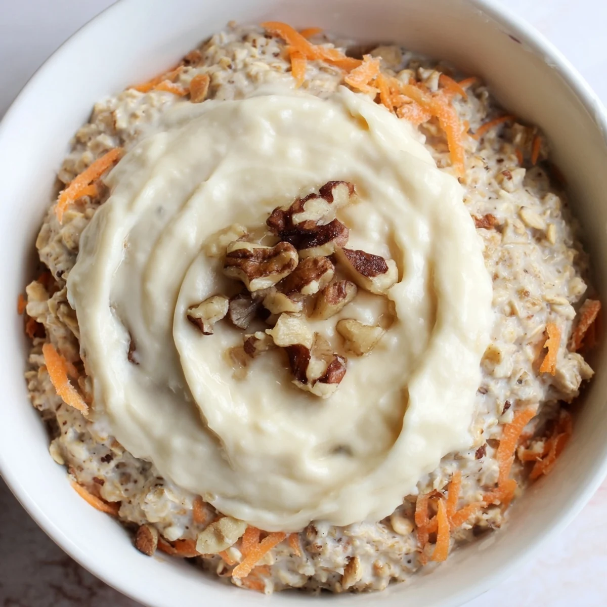 Creamy Carrot Cake Overnight Oats, layered beautifully with carrots and walnuts, ready to eat for breakfast.