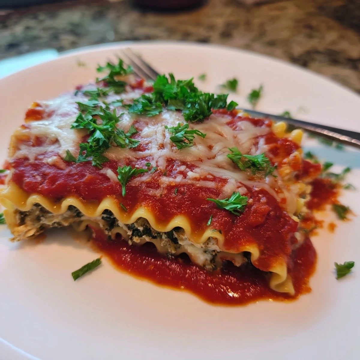 Close-up of Chicken and Spinach Lasagna Rolls revealing the creamy ricotta, tender chicken, and vibrant green spinach filling.