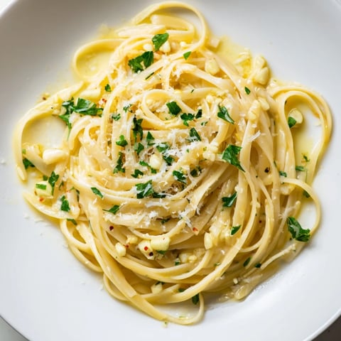 Golden garlic butter linguine, glistening with parsley, is a comforting Italian pasta dish.