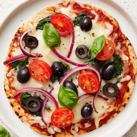 Golden-brown Crispy Tortilla Pizza, loaded with melted cheese and fresh, vibrant toppings.