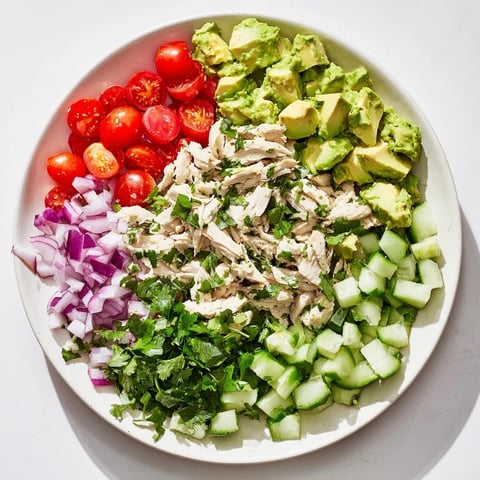 Bright and creamy Avocado Chicken Salad with tender chicken, juicy cherry tomatoes, and fresh cilantro, tossed in a zesty lime dressing.