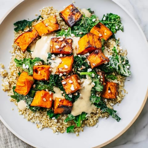 This colorful Light Coastal Bowl features roasted sweet potatoes, fresh kale, and a creamy lemon-tahini dressing.