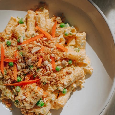 A close-up of a flavorful spicy peanut noodle salad, ready to be enjoyed as lunch.