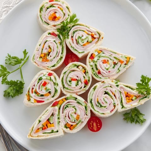 Freshly made smoked turkey pinwheels tree, filled with colorful veggies, ready to serve and enjoy at your gathering.