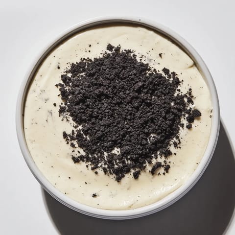 This picture shows a beautiful serving of vanilla pudding with crushed Oreos, ready to enjoy.