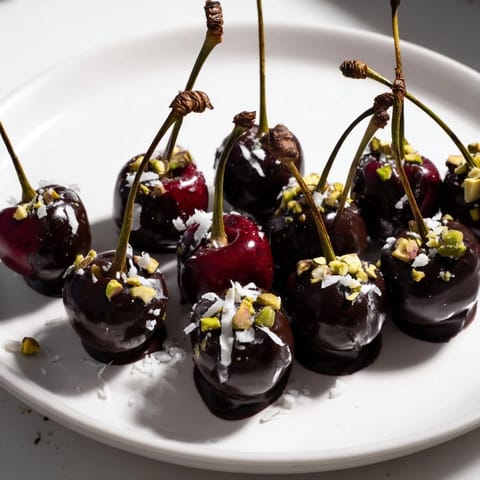 A close-up of glossy chocolate-covered cherry dessert bites, ready to be enjoyed as a sweet treat.