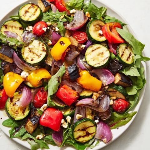 Enjoy a healthy Roasted Vegetable Salad with balsamic dressing, garnished with toasted nuts.