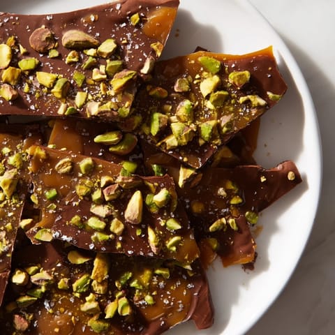 Homemade Pistachio Salted Caramel Bark presented with a sprinkle of flaky sea salt, perfect for sharing and gifting.