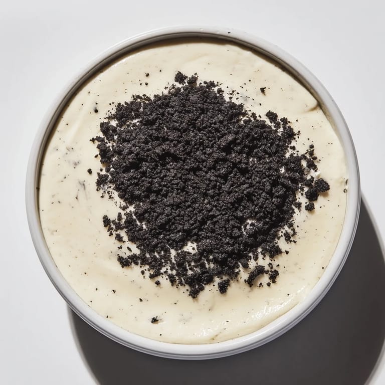 This picture shows a beautiful serving of vanilla pudding with crushed Oreos, ready to enjoy.