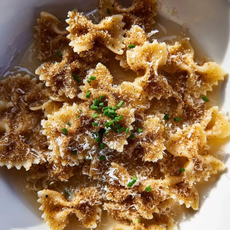 Savory Pasta Chip Cereal, with a sprinkle of chives, ready to be enjoyed as an appetizer.