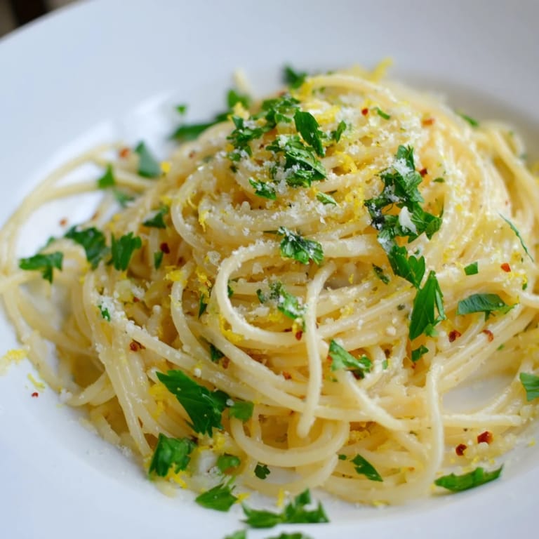 Steaming plate of garlic butter noodles, tossed in a flavorful sauce and ready to devour.
