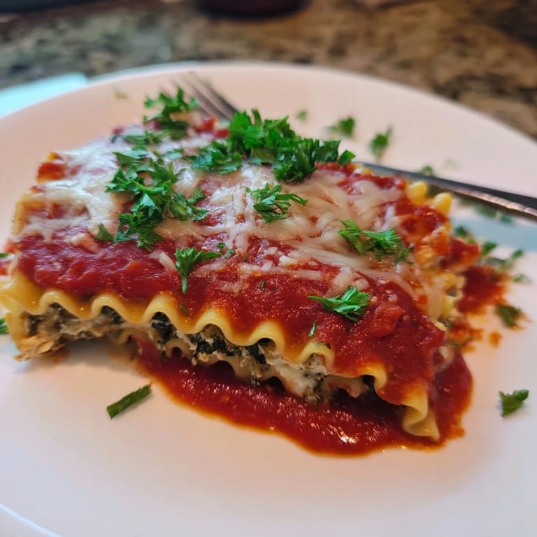 Close-up of Chicken and Spinach Lasagna Rolls revealing the creamy ricotta, tender chicken, and vibrant green spinach filling.